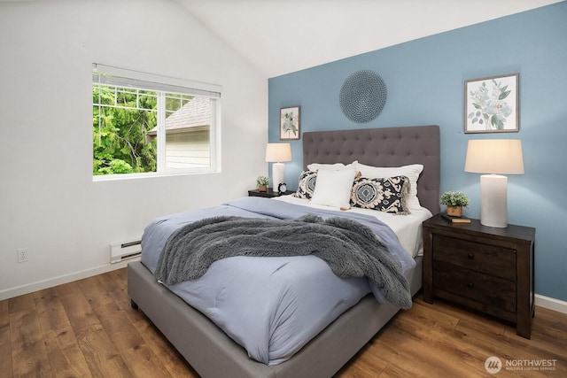 bedroom featuring vaulted ceiling, baseboard heating, wood finished floors, and baseboards