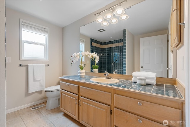 4037 220th Pl SE Unit 1105, Issaquah, WA 98029 - full bath featuring healthy amount of natural light, tile patterned floors, baseboards, and a tile shower
