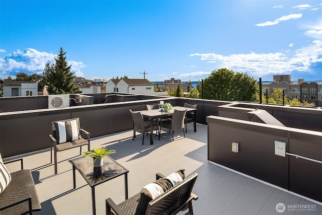 view of patio / terrace with outdoor dining area, a balcony, and a residential view