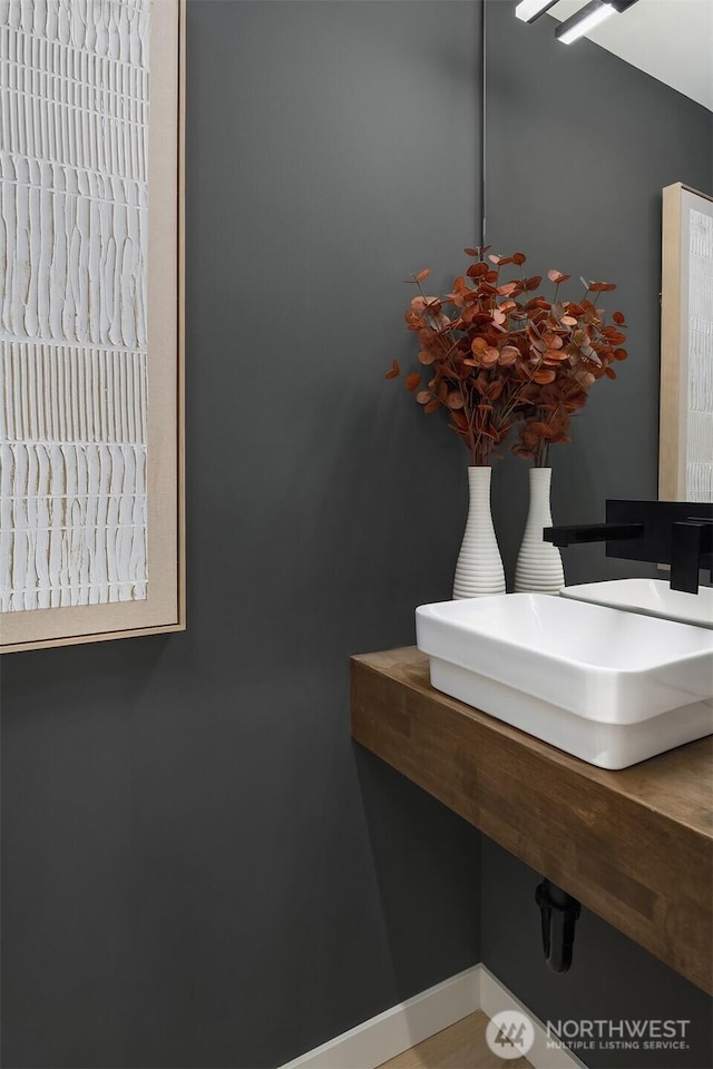bathroom featuring a sink and baseboards