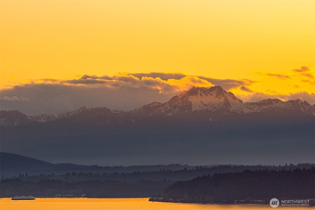 view of mountain background featuring a nearby body of water