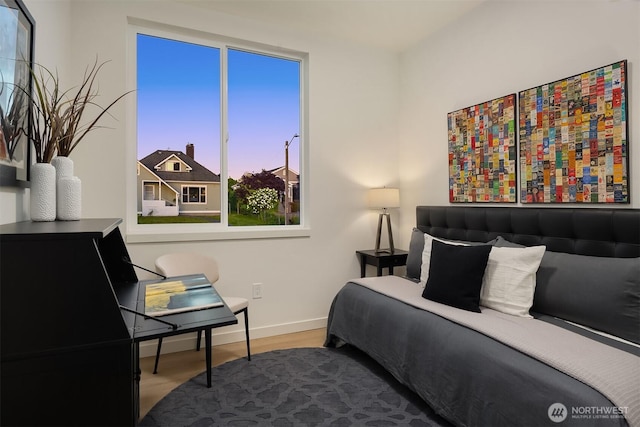 bedroom featuring baseboards and wood finished floors