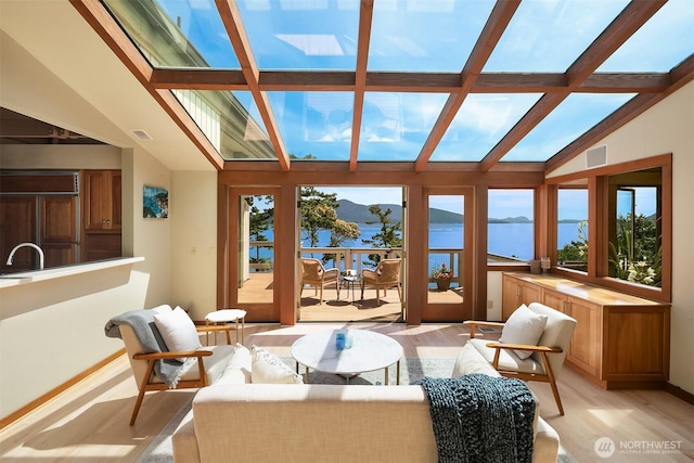871 Deer Point Rd, Orcas Island, WA 98279 - sunroom / solarium with plenty of natural light, wood finished floors, and a water view