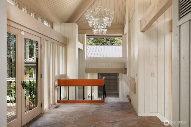 871 Deer Point Rd, Orcas Island, WA 98279 - foyer featuring a chandelier, wood ceiling, stone finish floors, and wooden walls