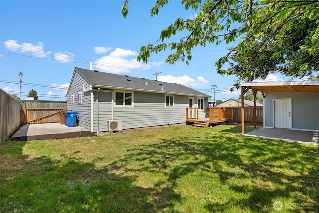 rear view of property with a wooden deck, a patio, and ac unit
