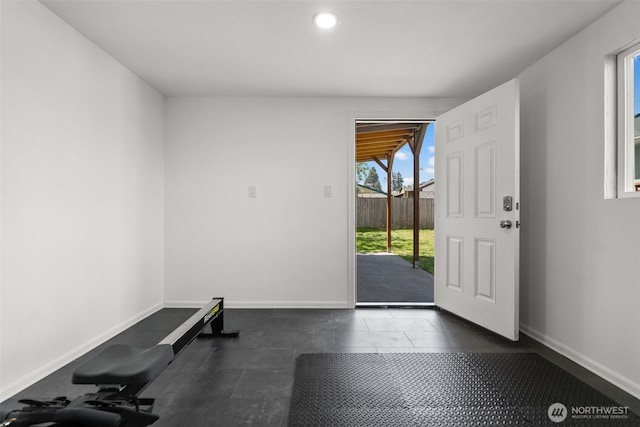 exercise room with baseboards, recessed lighting, and tile patterned flooring
