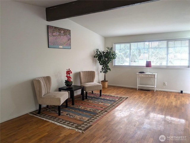 sitting room with wood finished floors and baseboards