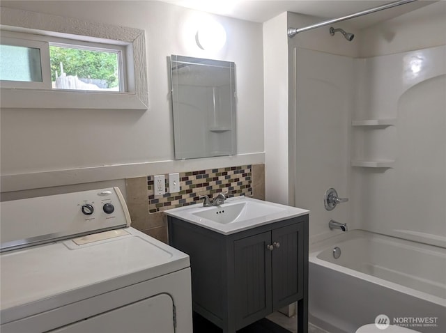 full bathroom with washer / clothes dryer, backsplash, shower / washtub combination, and vanity