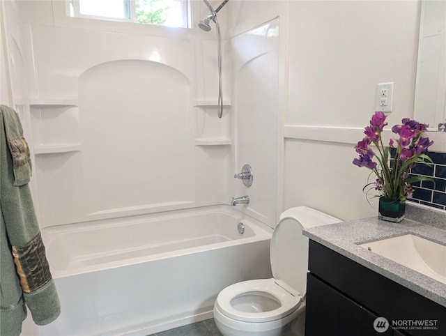 bathroom with shower / washtub combination, vanity, and toilet