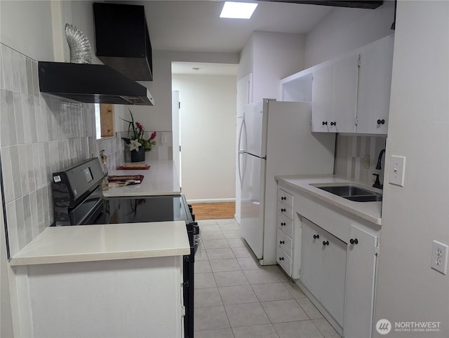 kitchen featuring black range with electric cooktop, tasteful backsplash, a sink, light tile patterned floors, and light countertops