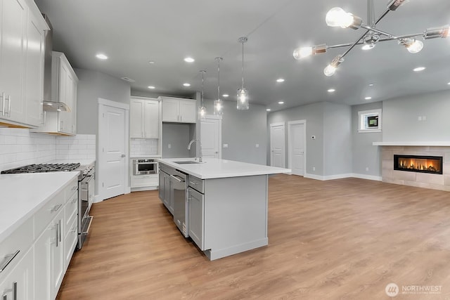 14130 15th Ave W, Lynnwood, WA 98087 - kitchen featuring stainless steel appliances, recessed lighting, open floor plan, light wood-style flooring, and light countertops