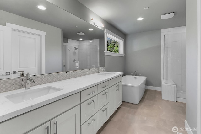 14130 15th Ave W, Lynnwood, WA 98087 - bathroom featuring a stall shower, a soaking tub, double vanity, recessed lighting, and baseboards
