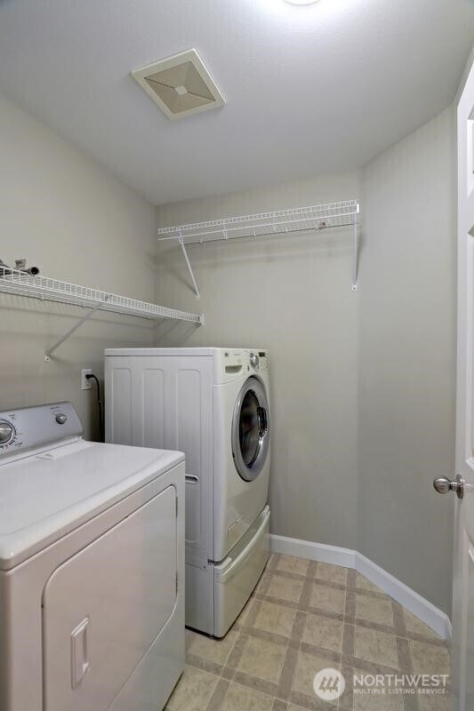18631 10th Ave SE, Bothell, WA 98012 - laundry room with washer and clothes dryer, baseboards, and light flooring