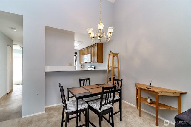 8408 18th Ave W Unit 10-202, Everett, WA 98204 - dining room with a chandelier, light colored carpet, and baseboards