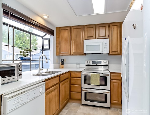 8408 18th Ave W Unit 10-202, Everett, WA 98204 - kitchen with white appliances, a sink, brown cabinets, and light countertops