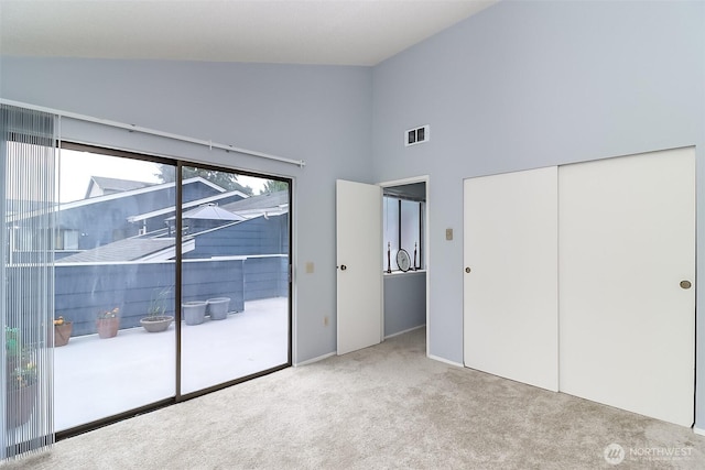 8408 18th Ave W Unit 10-202, Everett, WA 98204 - unfurnished bedroom featuring access to outside, carpet, high vaulted ceiling, and a closet