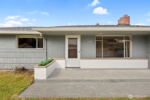 1113 S 72nd St, Tacoma, WA 98408 - property entrance featuring a chimney, covered porch, and roof with shingles