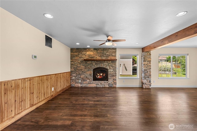 2060 5th St, Wenatchee, WA 98801 - unfurnished living room featuring a ceiling fan, wood-type flooring, wainscoting, a stone fireplace, and wood walls