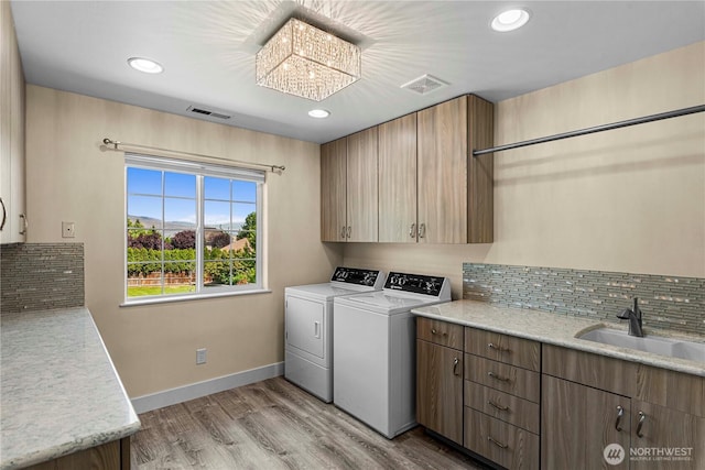 2060 5th St, Wenatchee, WA 98801 - laundry room featuring separate washer and dryer, cabinet space, light wood finished floors, baseboards, and recessed lighting