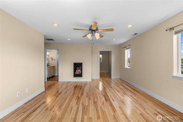 2060 5th St, Wenatchee, WA 98801 - unfurnished living room featuring baseboards, light wood-style floors, recessed lighting, a ceiling fan, and a lit fireplace