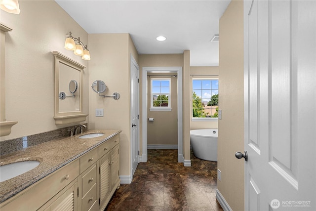 2060 5th St, Wenatchee, WA 98801 - full bath featuring baseboards, double vanity, and a freestanding tub