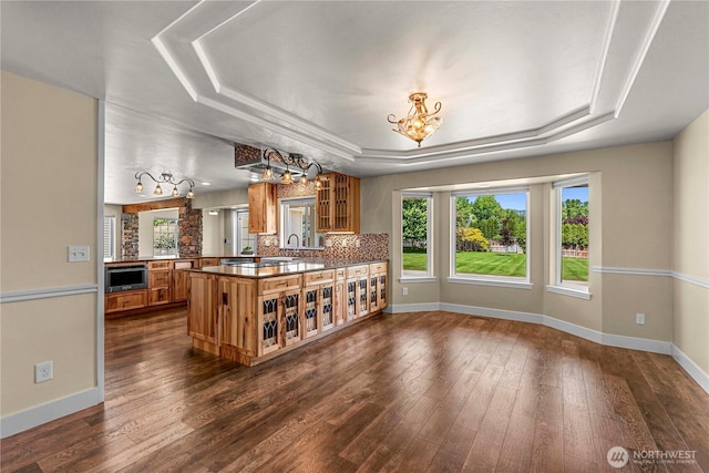 2060 5th St, Wenatchee, WA 98801 - kitchen featuring a tray ceiling, a chandelier, brown cabinets, and baseboards