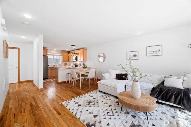 1123 N 94th St Unit A, Seattle, WA 98103 - living room featuring recessed lighting, light wood-style flooring, and a chandelier