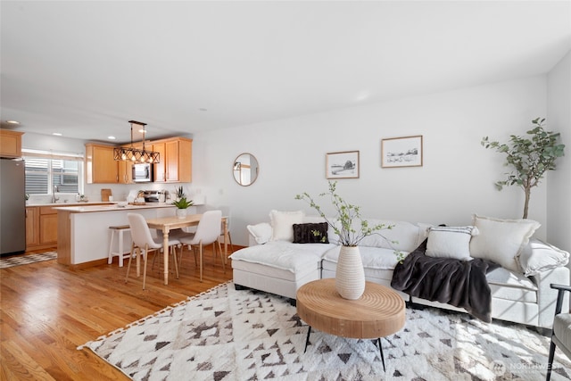 1123 N 94th St Unit A, Seattle, WA 98103 - living room with recessed lighting, light wood finished floors, and a chandelier