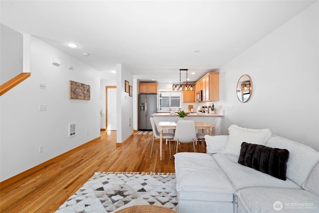 1123 N 94th St Unit A, Seattle, WA 98103 - living room featuring light wood finished floors, baseboards, and recessed lighting