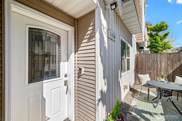 1123 N 94th St Unit A, Seattle, WA 98103 - property entrance featuring board and batten siding, fence, a patio area, and outdoor dining area