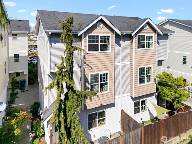 1123 N 94th St Unit A, Seattle, WA 98103 - view of front facade with fence and a shingled roof