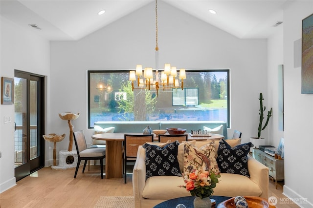 dining space featuring wood finished floors, a chandelier, high vaulted ceiling, baseboards, and recessed lighting