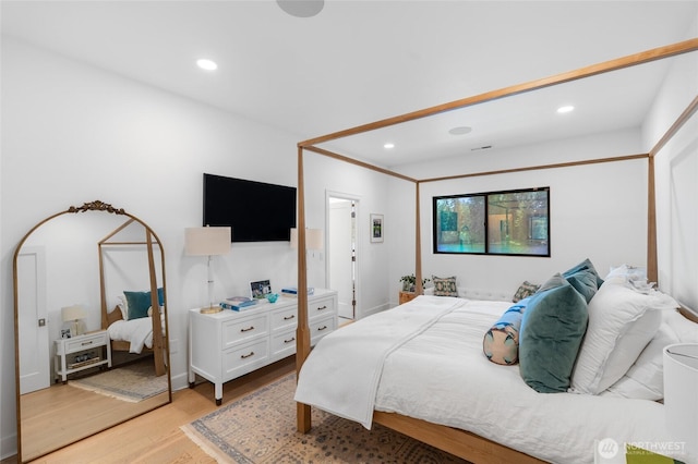 bedroom featuring light wood finished floors and recessed lighting