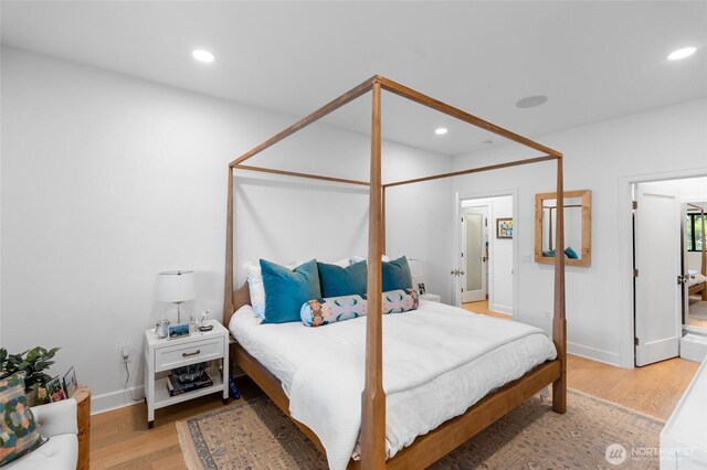 bedroom with light wood-type flooring, baseboards, and recessed lighting