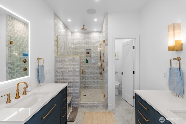 bathroom featuring a shower stall, toilet, two vanities, recessed lighting, and marble finish floors