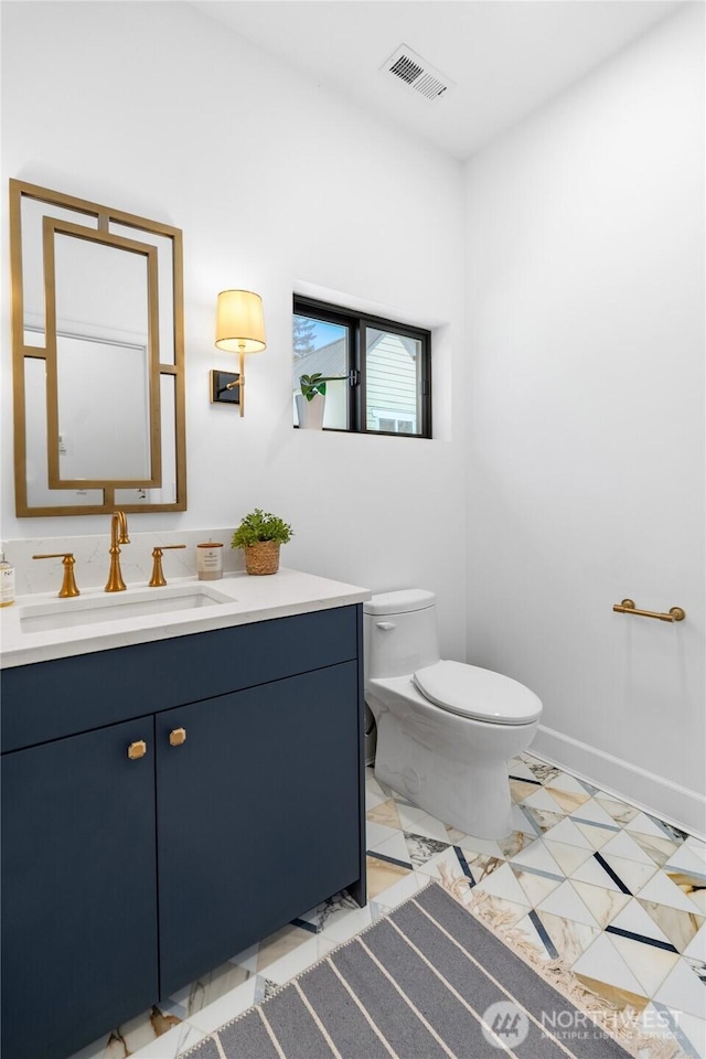 bathroom with vanity and toilet