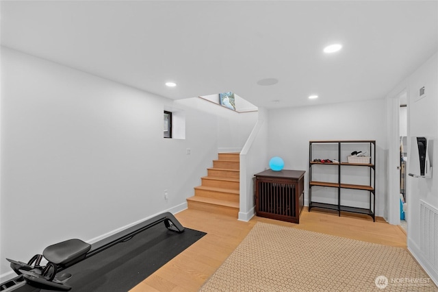 workout area with wood finished floors, recessed lighting, and baseboards