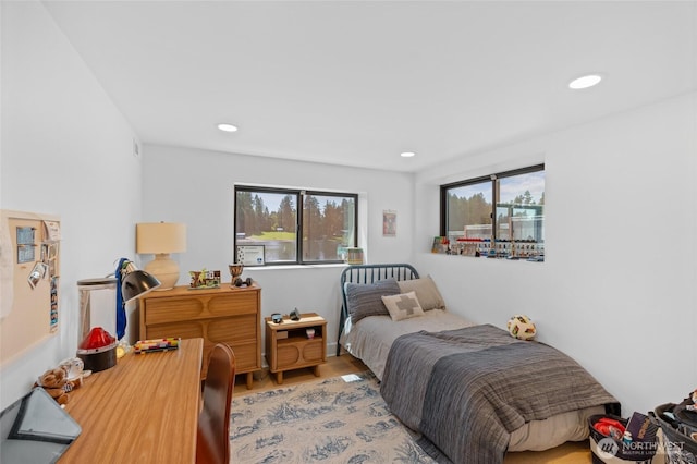 bedroom with recessed lighting and light wood-style floors