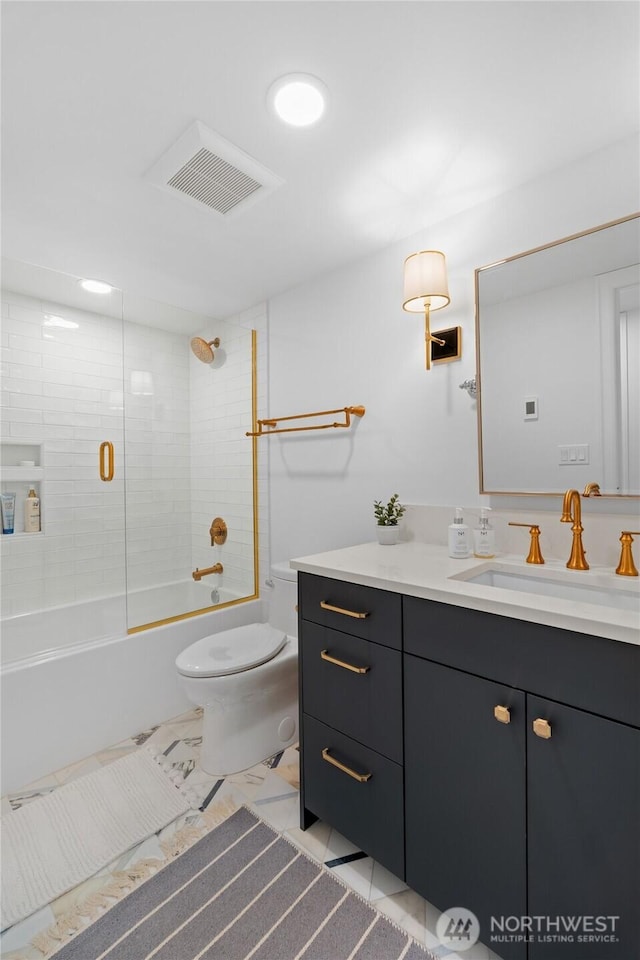 bathroom featuring toilet, vanity, tub / shower combination, and marble finish flooring