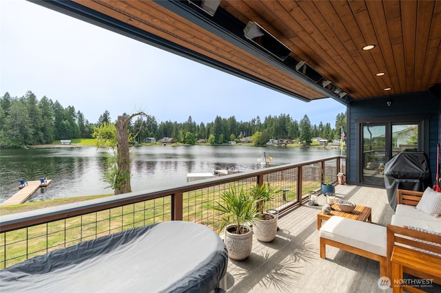 deck with a water view, an outdoor hangout area, and area for grilling