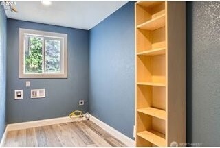 laundry room with wood finished floors, electric dryer hookup, baseboards, and hookup for a washing machine