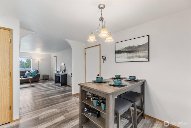 60 E Treewater Pl, Shelton, WA 98584 - dining area featuring arched walkways, wood finished floors, a chandelier, and baseboards