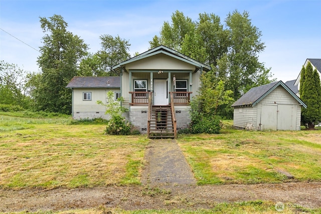 1025 NW Prindle St, Chehalis, WA 98532 - view of front facade with crawl space, an outbuilding, a porch, stairs, and a front yard