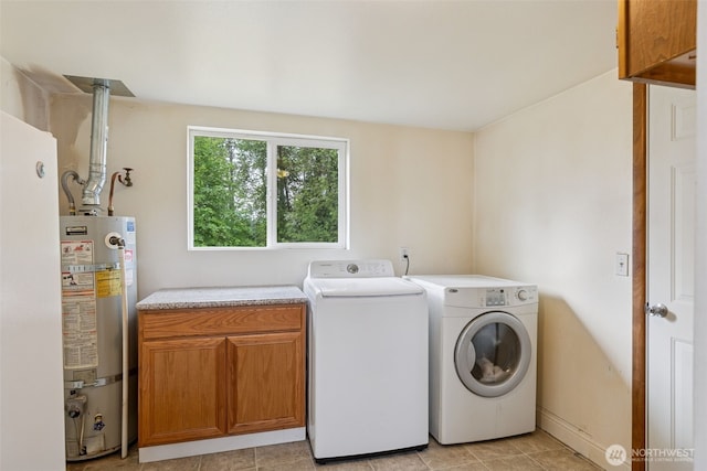 1025 NW Prindle St, Chehalis, WA 98532 - washroom featuring cabinet space, water heater, independent washer and dryer, and light tile patterned floors