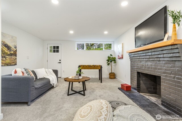 carpeted living room with recessed lighting, a brick fireplace, and baseboards