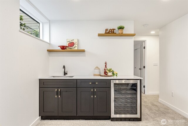 indoor wet bar with wine cooler, light carpet, baseboards, and recessed lighting