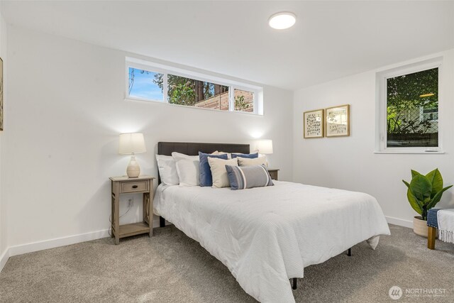 bedroom featuring light colored carpet and baseboards