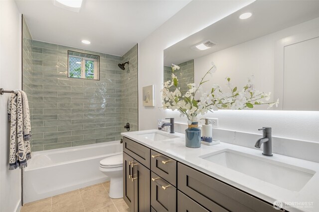 bathroom featuring tile patterned flooring, toilet, shower / bath combination, double vanity, and recessed lighting