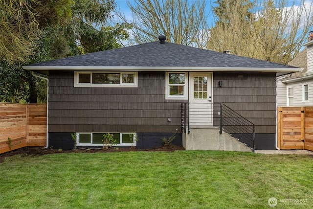 back of house featuring a shingled roof