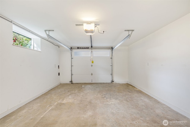 garage featuring a garage door opener and baseboards